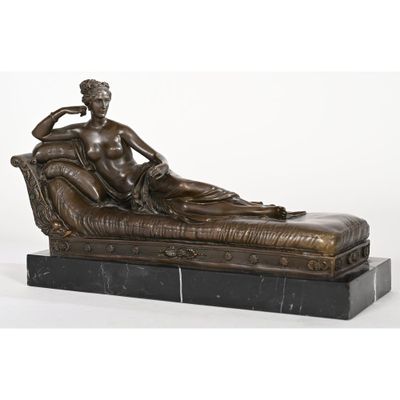 an image of a bronze statue of a woman sitting on a couch