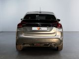 a silver car parked in a room with a white wall