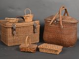 three wicker baskets with handles and handles on a gray background