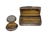 a small metal box with a mirror inside of it