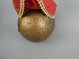 a gold ball with a red hat on it