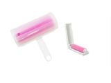 a pink and white roller brush and a pink and white comb