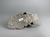 an image of a rock with holes in it on a gray surface
