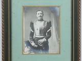 an old photo of a man in a military uniform holding a rifle