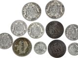 an image of a group of old coins on a white surface