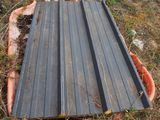 a metal sheet laying on the ground in the grass