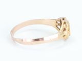 a close up of a gold ring with a diamond in the center