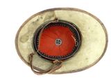 a hat that has a red button on it
