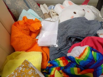 a box full of clothes and stuffed animals inside of it