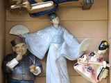 many figurines in a box that are in the shape of people