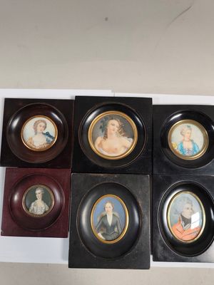four framed miniature portraits of women and children in black frames