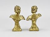 pair of brass figurines of a boy and a girl
