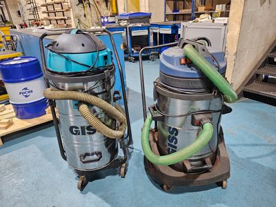 two vacuums sitting next to each other on the floor