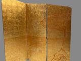 gold leafed screen with a bird on it