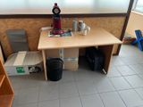 a small table with a clock on it in a room