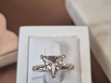 a white box with a ring in it on a table