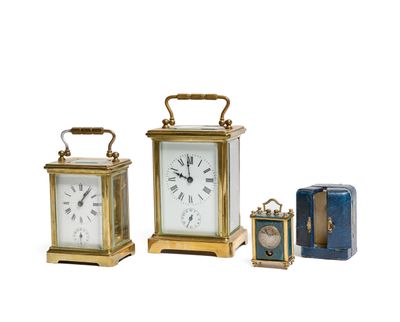 several different types of clocks are displayed on a white surface
