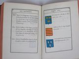 an open book with a picture of a coat of arms and a coat of arms on it