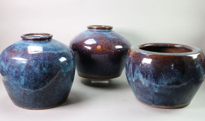 three vases that are sitting on a table