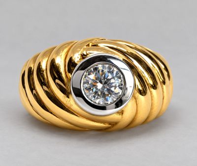 a yellow gold ring with a diamond set in the center