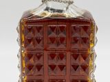 an image of a bottle of liquor sitting on top of a table