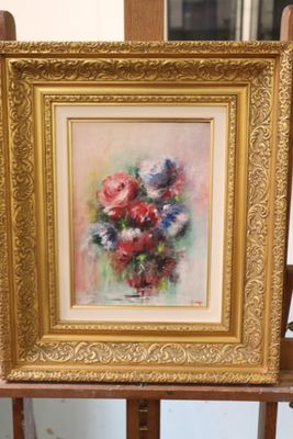 a picture of a painting of flowers in a vase on a easel