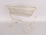 an old white wire basket on a stand on a white background