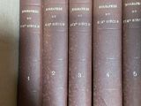 several old books are stacked on top of each other on a shelf