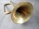 a brass trumpet that is sitting on a table
