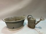 pair of antique metal watering cans with handles and handles
