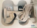 a white box with a pair of shoes and a cable in it