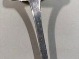 a silver spoon with a mushroom shaped handle on it