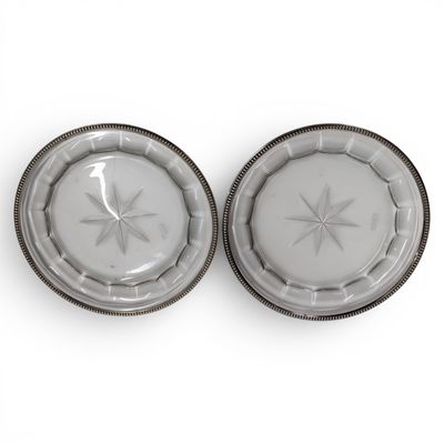 two plates with a star design on them on a white surface