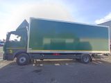 a large green truck parked in a parking lot