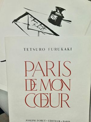 a book that is sitting on top of a pile of papers