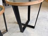 two tables with a glass top and metal legs in a warehouse