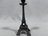 a small black candle holder on a white background