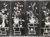 four panels of black and white flowers and vases on stands