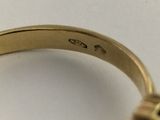 an image of a gold ring with a black diamond