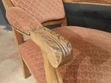 a wooden chair with a pink upholstered upholstered seat