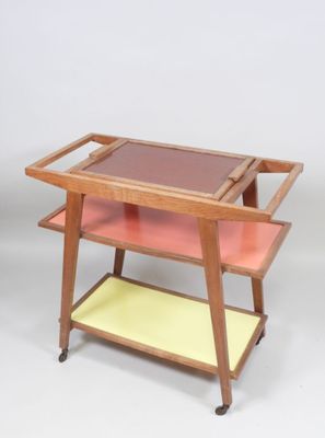 an image of a wooden serving cart with two trays on it