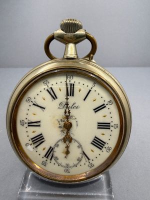 a gold clock with roman numerals on the face