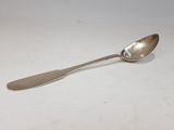 silver spoon on a white surface with a small silver spoon on it
