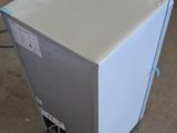 an image of a refrigerator in a warehouse with a box in the background