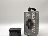 garmin gps watch in a box next to it ' s packaging