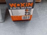 a box of wokin b - metal hole saw sitting on the floor