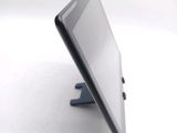 a tablet that is sitting on a stand on a table