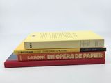 three books stacked on top of each other on a table