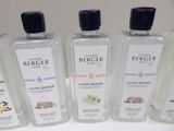 four bottles of colognes are lined up on a table
