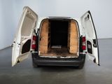 a white van with its doors open in a room
